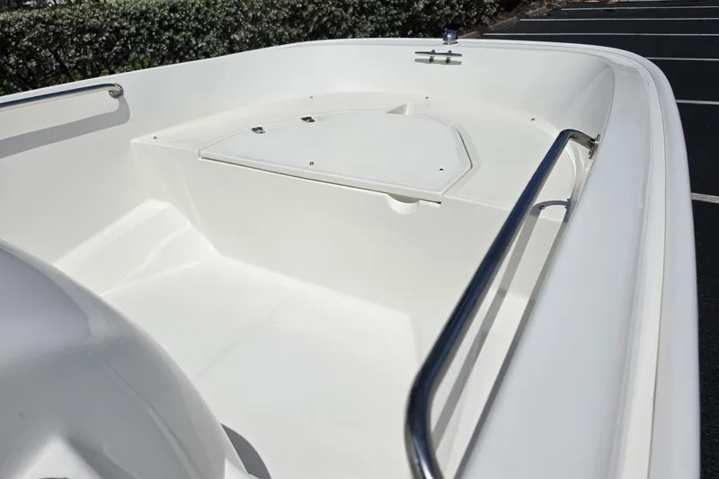 Slide: The Image of 2012 Boston Whaler 15 Super Sport boat interior with white deck and stainless steel railing. - 4