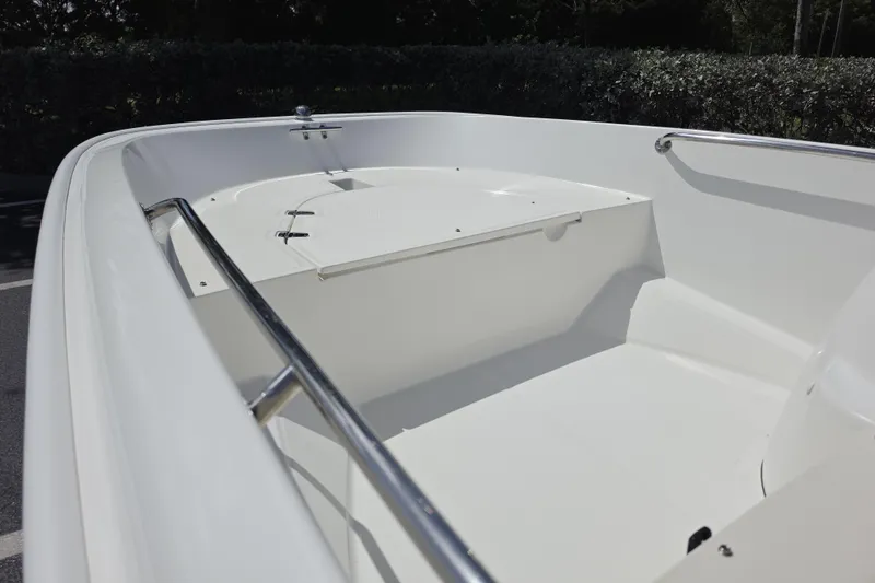 Slide: The Image of 2012 Boston Whaler 15 Super Sport boat interior with sleek white design and stainless steel rails. - 9