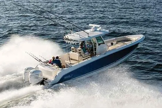 Slide: The Image of Manufacturer Provided Image: 2019 Boston Whaler 330 Outrage speeding on the water with fishing rods. - 10