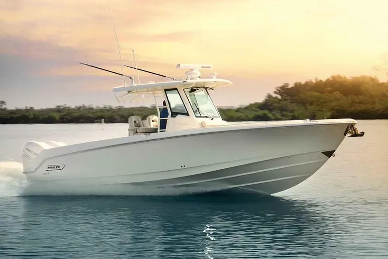 Slide: The Image of Manufacturer Provided Image: 2019 Boston Whaler 330 Outrage boat cruising on calm water at sunset. - 11