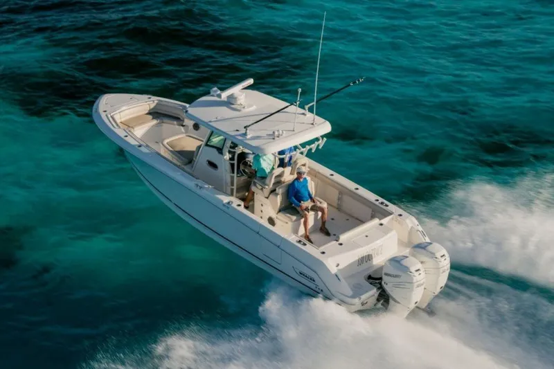 Slide: The Image of Manufacturer Provided Image: 2019 Boston Whaler 330 Outrage cruising on clear blue water. - 12