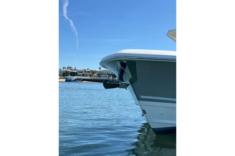 Slide: The Image of 2019 Boston Whaler 330 Outrage boat on calm water, clear sky background. - 27