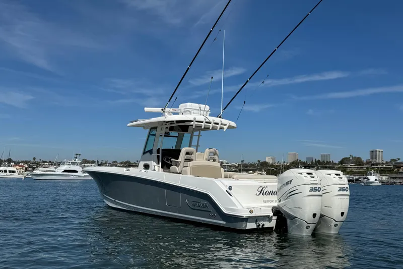 Slide: The Image of 2019 Boston Whaler 330 Outrage boat with twin Mercury engines on calm water. - 3
