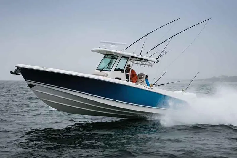 Slide: The Image of Manufacturer Provided Image: 2019 Boston Whaler 330 Outrage boat speeding on water with fishing rods. - 8