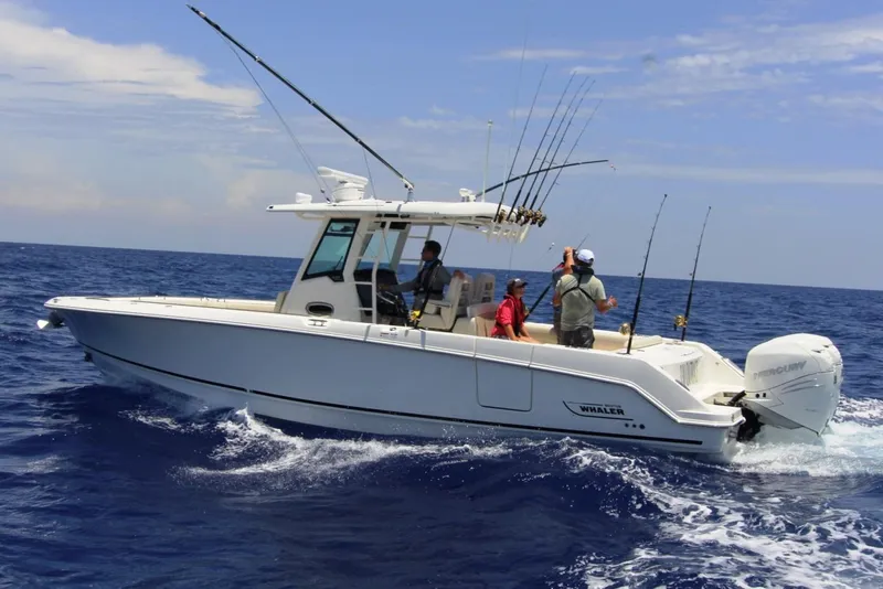 Slide: The Image of Manufacturer Provided Image: 2019 Boston Whaler 330 Outrage boat cruising on open water with fishing rods. - 9