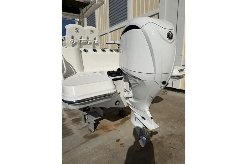 Slide: The Image of 2023 Edgewater 230CC boat with a sleek white outboard motor. - 4