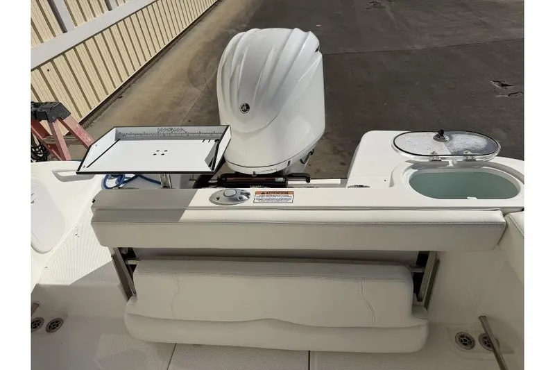 Slide: The Image of 2023 Edgewater 230CC boat interior with engine and seating area. - 5
