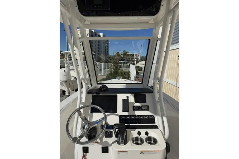 Slide: The Image of 2023 Edgewater 230CC boat cockpit with steering wheel and control panel. - 6