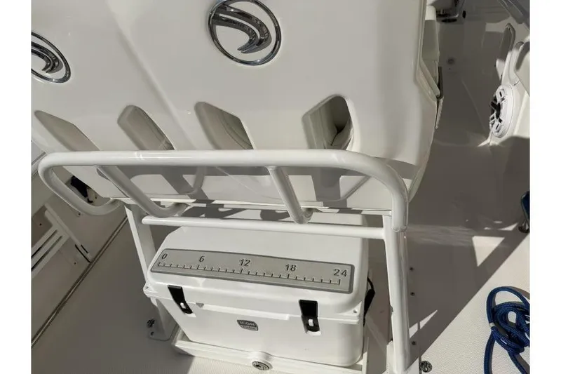 Slide: The Image of 2023 Edgewater 230CC boat interior with cooler and rod holders. - 7