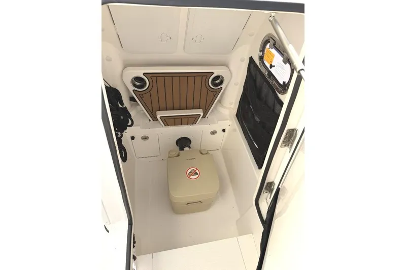 Slide: The Image of Interior view of 2023 Edgewater 230CC boat cabin with storage and seating. - 9
