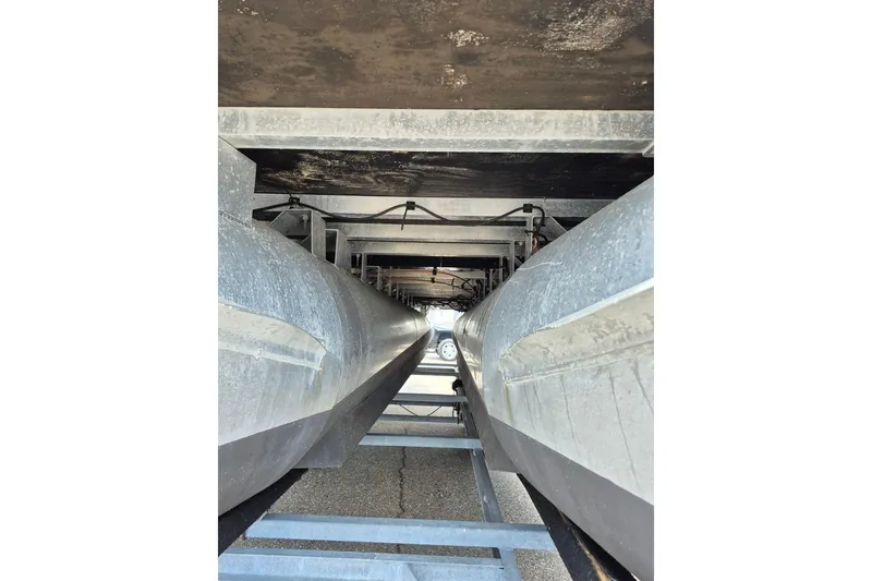 Slide: The Image of Underneath view of a 2022 Sport Pontoons Tritoon Slide, showcasing pontoons and structural details. - 24