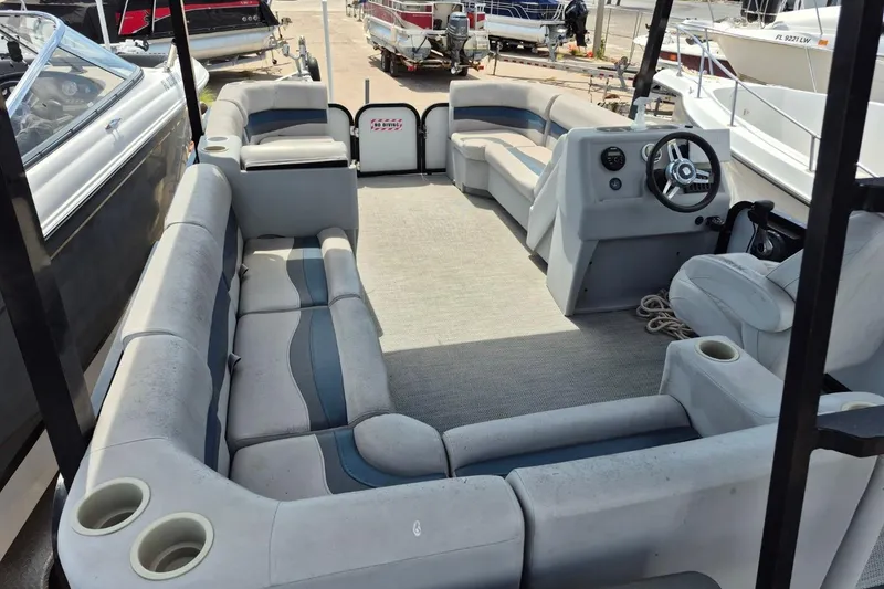 Slide: The Image of 2022 Sport Pontoons Tritoon Slide interior with spacious seating and steering console. - 10
