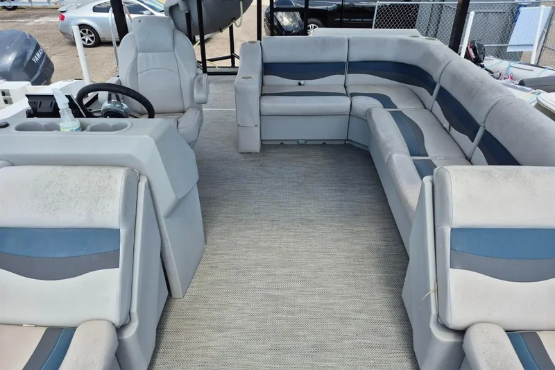 Slide: The Image of 2022 Sport Pontoons Tritoon Slide interior with spacious seating and steering console. - 13