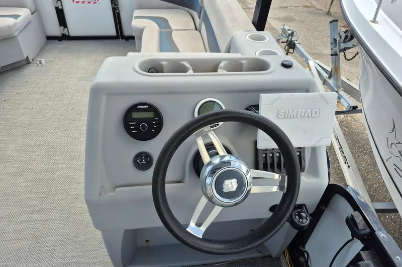 Slide: The Image of 2022 Sport Pontoons Tritoon Slide dashboard with steering wheel and navigation controls. - 18