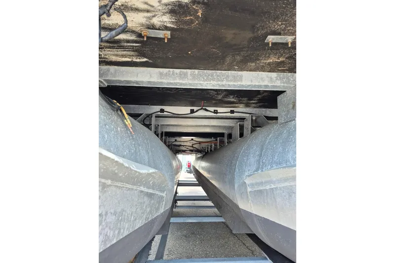 Slide: The Image of Underneath view of a 2022 Sport Pontoons Tritoon Slide, showcasing pontoons and structural details. - 23