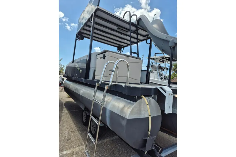 Slide: The Image of 2022 Sport Pontoons Tritoon Slide with ladder and upper deck slide, parked outdoors. - 8