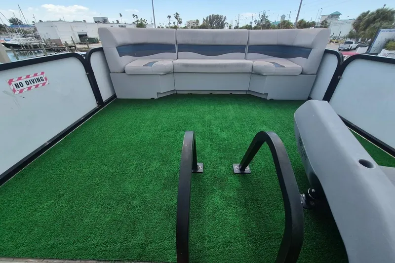Slide: The Image of 2022 Sport Pontoons Tritoon Slide with green deck, seating, and "No Diving" sign. - 19