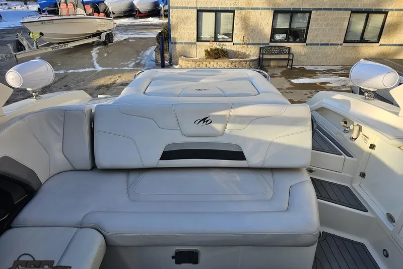 Slide: The Image of 2011 Monterey 328SS Super Sport boat interior with white seating and outdoor setting. - 100