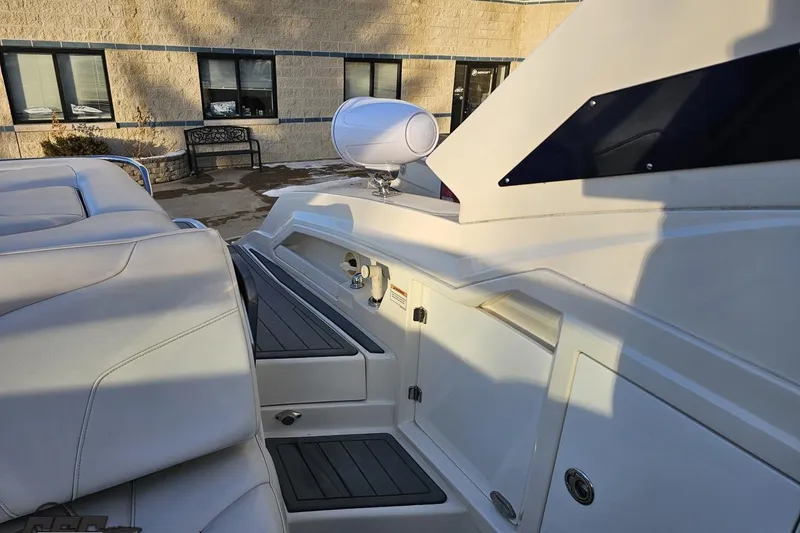 Slide: The Image of 2011 Monterey 328SS Super Sport boat interior with white seating and storage compartments. - 101