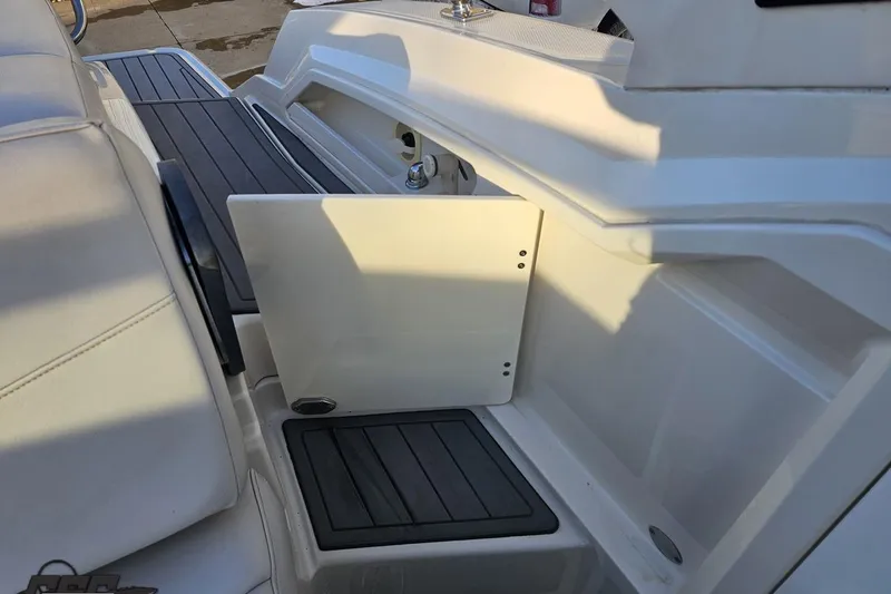 Slide: The Image of Interior view of a 2011 Monterey 328SS Super Sport boat, featuring seating and storage compartments. - 103