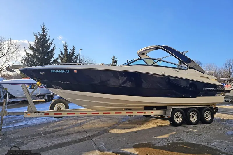 Slide: The Image of 2011 Monterey 328SS Super Sport boat on trailer under clear blue sky. - 11
