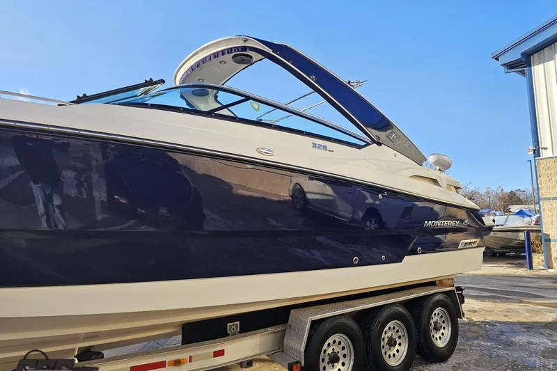 Slide: The Image of 2011 Monterey 328SS Super Sport boat on trailer, side view under clear blue sky. - 12