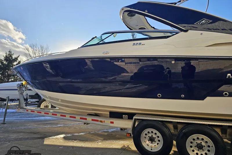Slide: The Image of 2011 Monterey 328SS Super Sport boat on trailer under clear sky. - 15