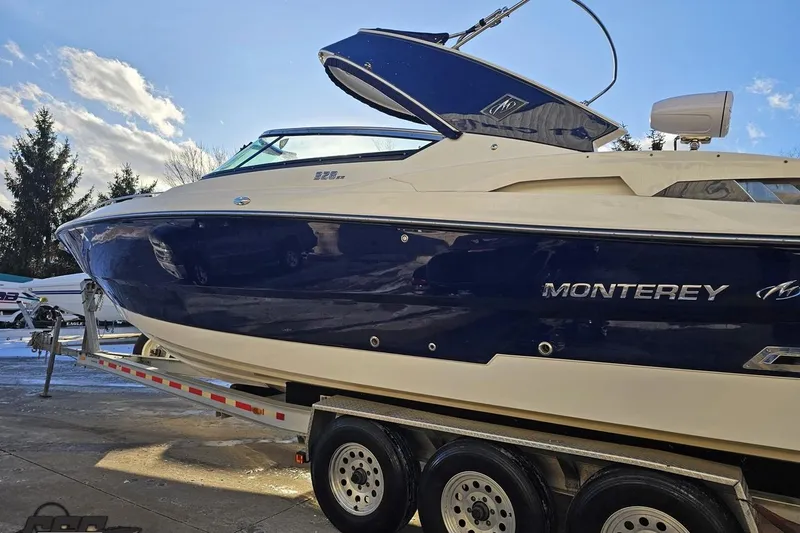 Slide: The Image of 2011 Monterey 328SS Super Sport boat on trailer under blue sky. - 16
