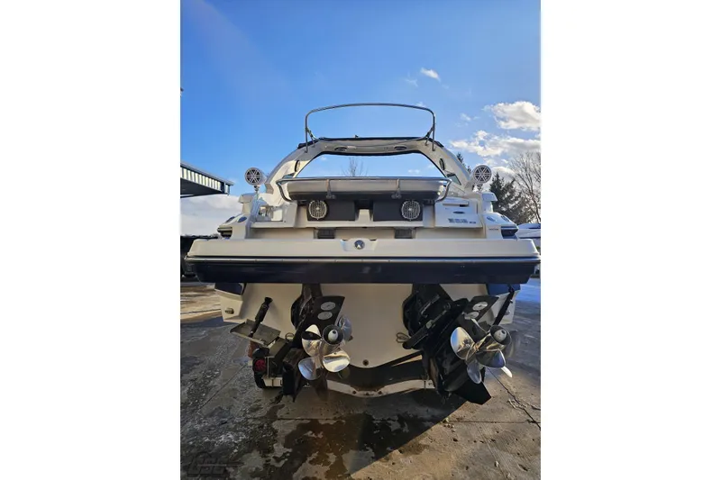 Slide: The Image of 2011 Monterey 328SS Super Sport boat rear view with dual propellers under clear sky. - 19