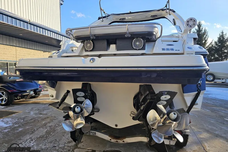Slide: The Image of 2011 Monterey 328SS Super Sport boat with dual propellers, parked outdoors. - 20