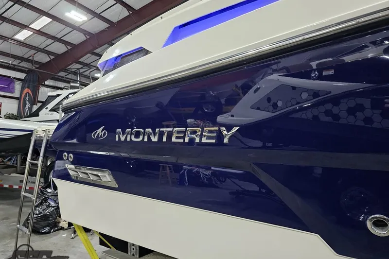 Slide: The Image of 2011 Monterey 328SS Super Sport boat in a showroom, showcasing sleek design and branding. - 21