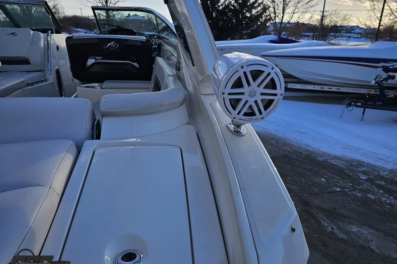 Slide: The Image of 2011 Monterey 328SS Super Sport boat interior with speaker, white seating, and snowy background. - 26