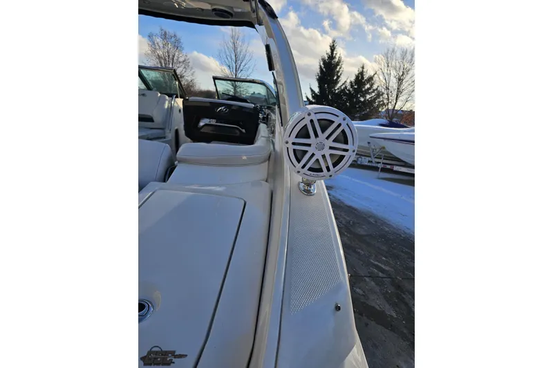 Slide: The Image of 2011 Monterey 328SS Super Sport boat with speaker, parked outdoors on a snowy day. - 27