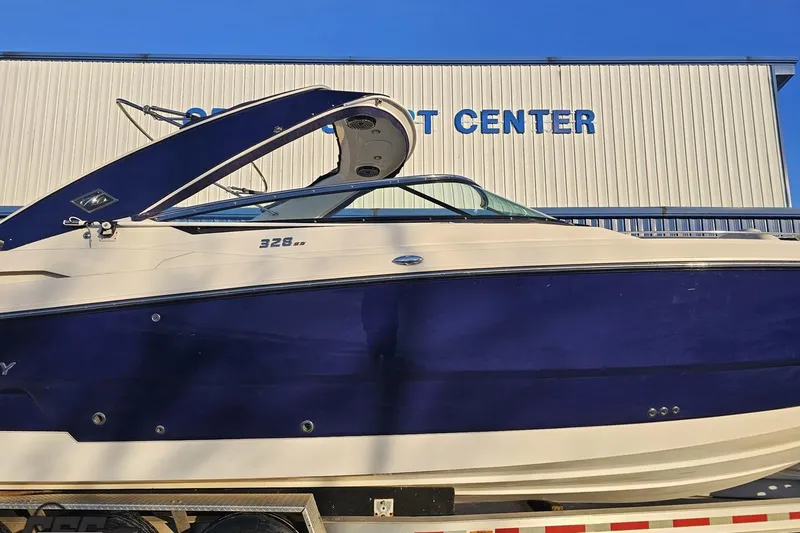 Slide: The Image of 2011 Monterey 328SS Super Sport boat displayed at a sport center. - 3