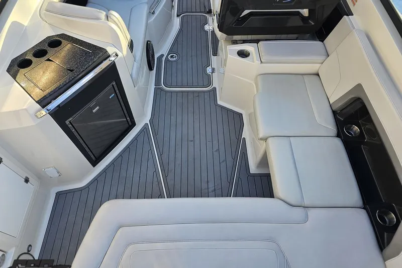 Slide: The Image of Interior of a 2011 Monterey 328SS Super Sport boat with seating and kitchenette. - 31
