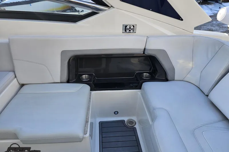 Slide: The Image of 2011 Monterey 328SS Super Sport boat interior with white seating and cup holders. - 40