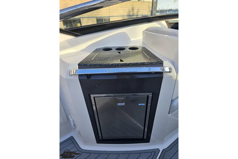 Slide: The Image of 2011 Monterey 328SS Super Sport boat interior with built-in kitchenette and storage. - 42