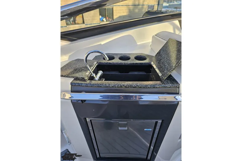 Slide: The Image of 2011 Monterey 328SS Super Sport boat interior with sink and storage area. - 44