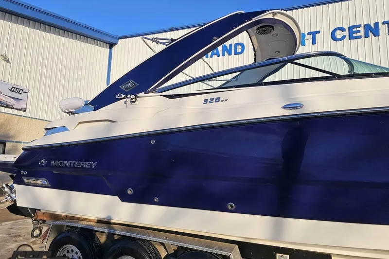 Slide: The Image of 2011 Monterey 328SS Super Sport boat displayed at a marine center. - 5