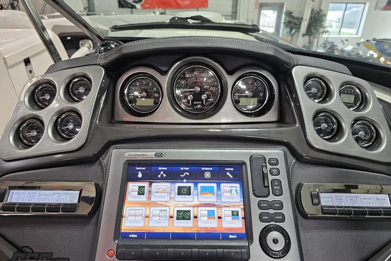 Slide: The Image of Dashboard of a 2011 Monterey 328SS Super Sport boat with gauges and touchscreen display. - 57
