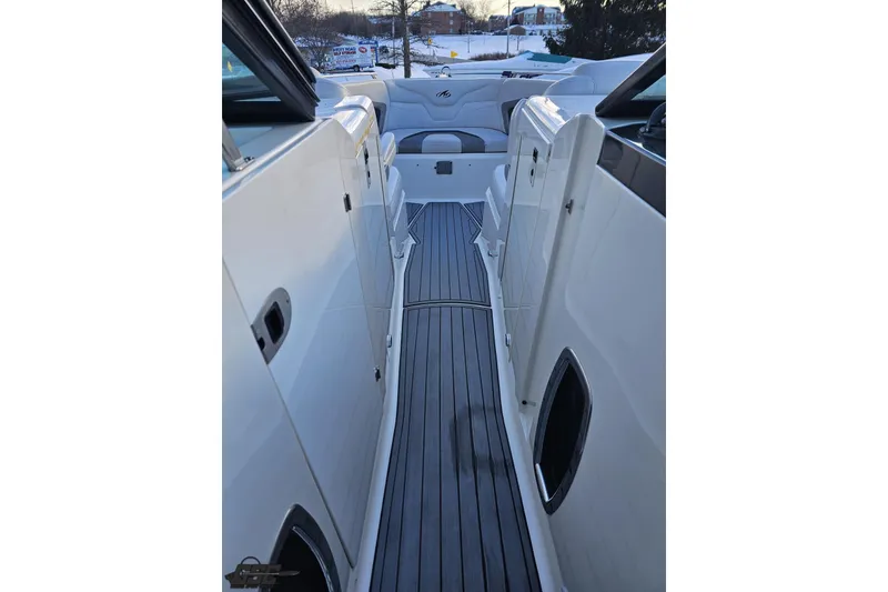 Slide: The Image of 2011 Monterey 328SS Super Sport boat interior with sleek white design and gray flooring. - 64