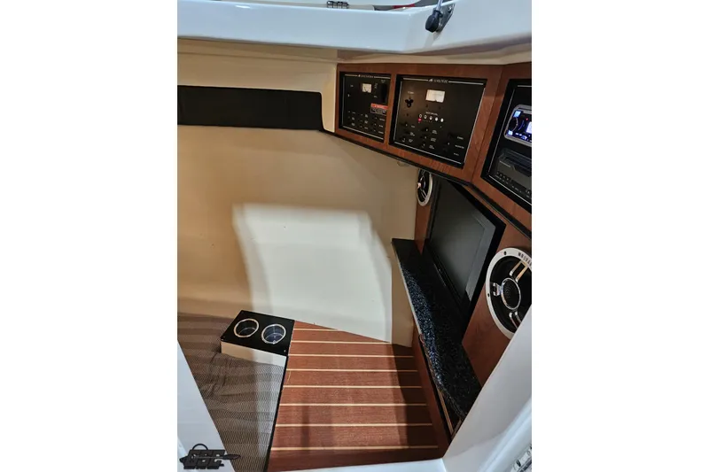 Slide: The Image of Interior of 2011 Monterey 328SS Super Sport boat with control panels and wood accents. - 68