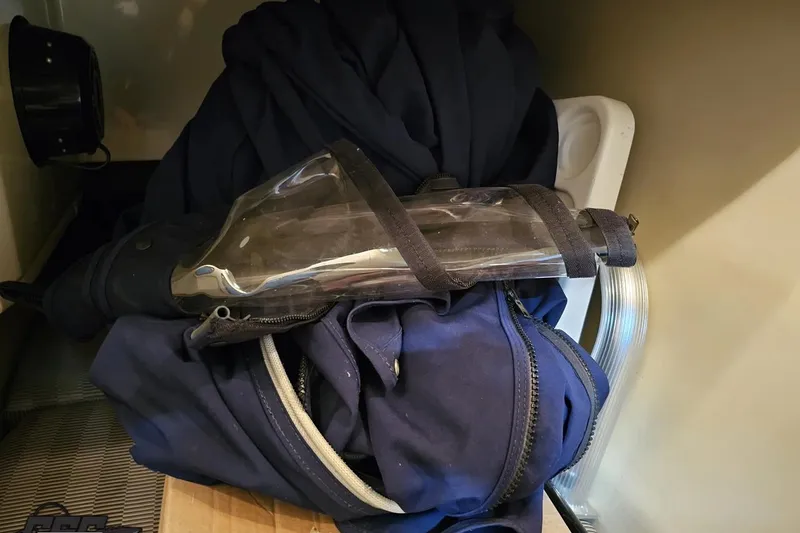 Slide: The Image of Diving gear and wetsuit stored in a compartment of a 2011 Monterey 328SS Super Sport boat. - 74