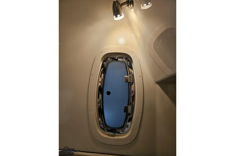 Slide: The Image of Interior cabin window of 2011 Monterey 328SS Super Sport boat, illuminated by overhead light. - 75
