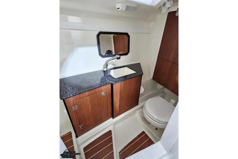 Slide: The Image of 2011 Monterey 328SS Super Sport boat bathroom with wood cabinets and granite countertop. - 79