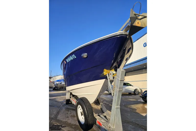 Slide: The Image of 2011 Monterey 328SS Super Sport boat on trailer, parked outdoors under clear blue sky. - 8