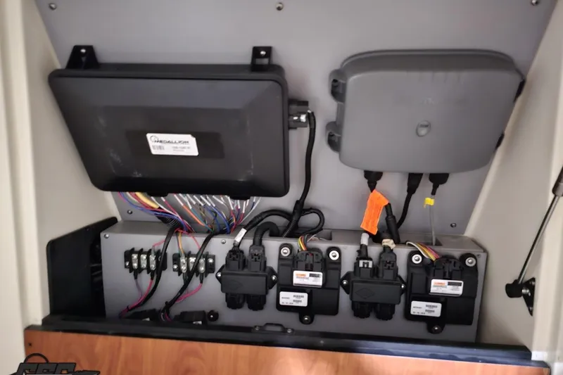 Slide: The Image of Electrical panel inside a 2011 Monterey 328SS Super Sport boat, featuring wiring and components. - 82