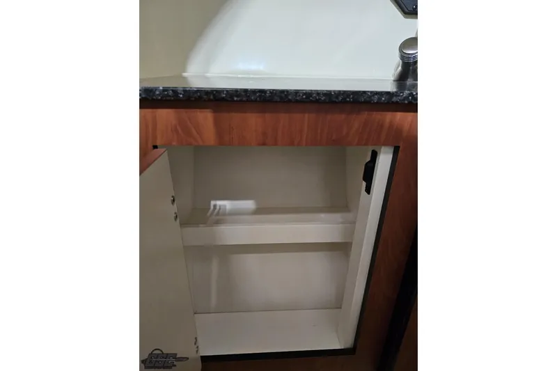 Slide: The Image of Open cabinet in 2011 Monterey 328SS Super Sport boat interior. - 85