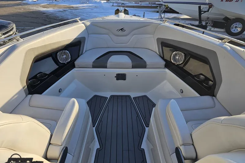 Slide: The Image of Interior of a 2011 Monterey 328SS Super Sport boat with cushioned seating and speakers. - 86
