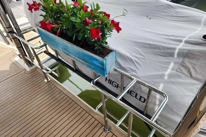 Slide: The Image of Deck of 2020 Leopard 45 yacht with vibrant red flowers in a blue planter. - 10